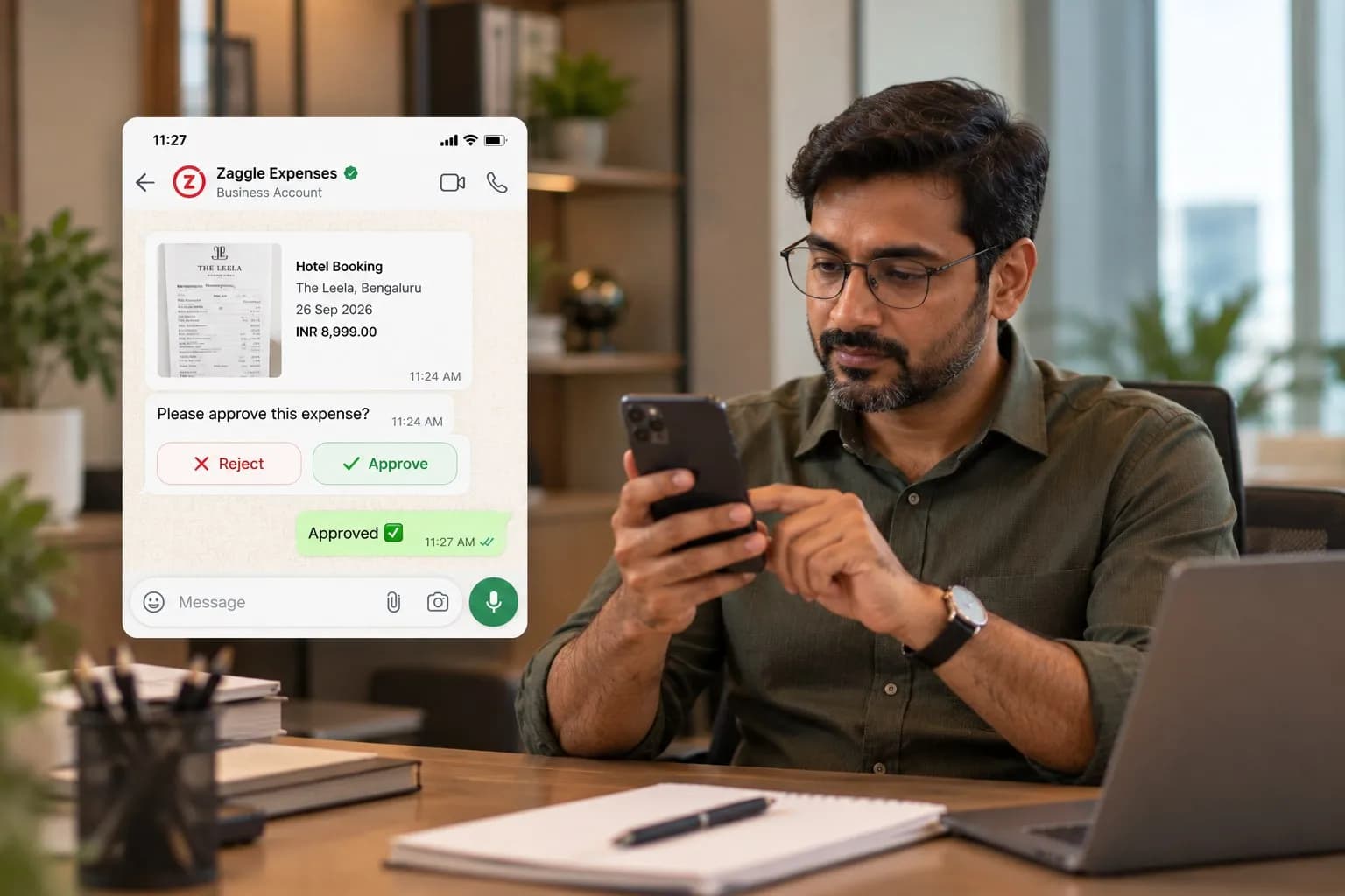 A finance manager at his desk approves an expense from the Zaggle Expenses chat on WhatsApp